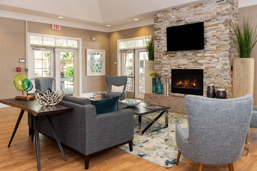 a living room with a fireplace and a tv