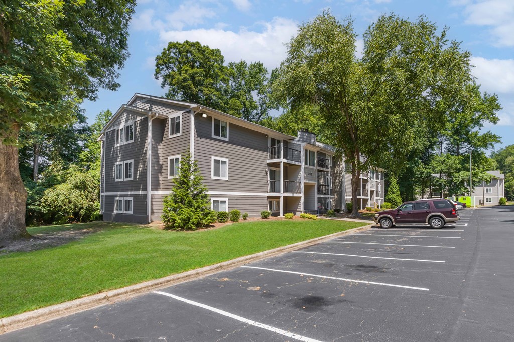 an empty parking lot in front of an apartment building