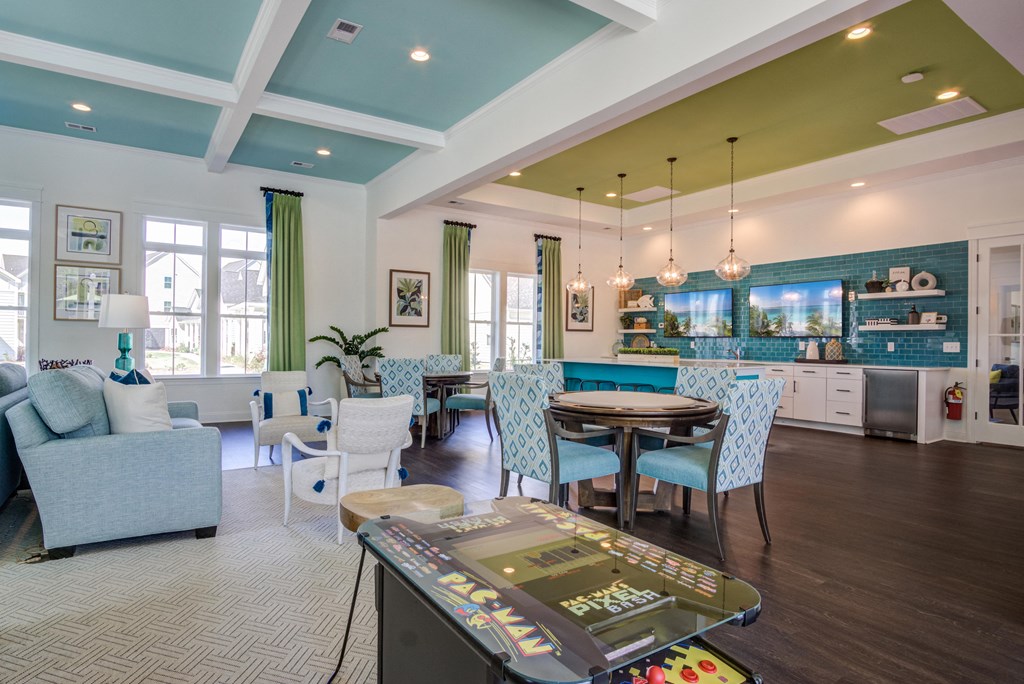 a living room with a table and chairs and a kitchen
