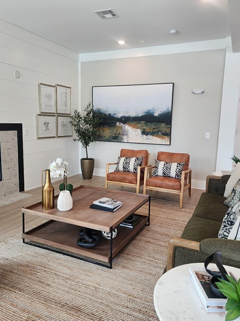 Living room with wood-style floors and natural light in 2 bedroom Opelika apartment