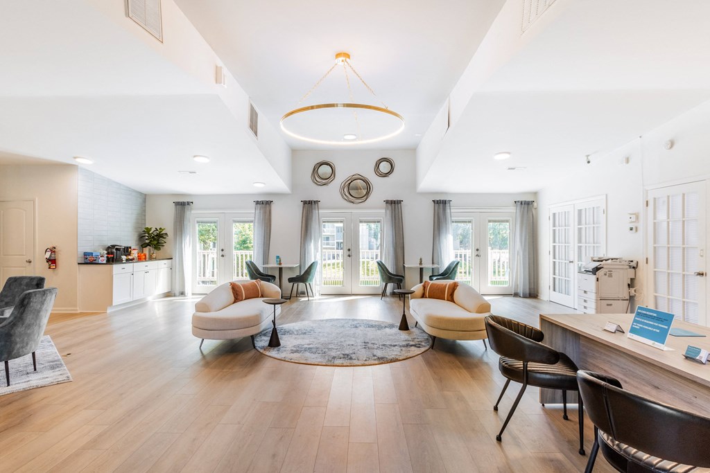 a living room with couches and chairs and a round rug