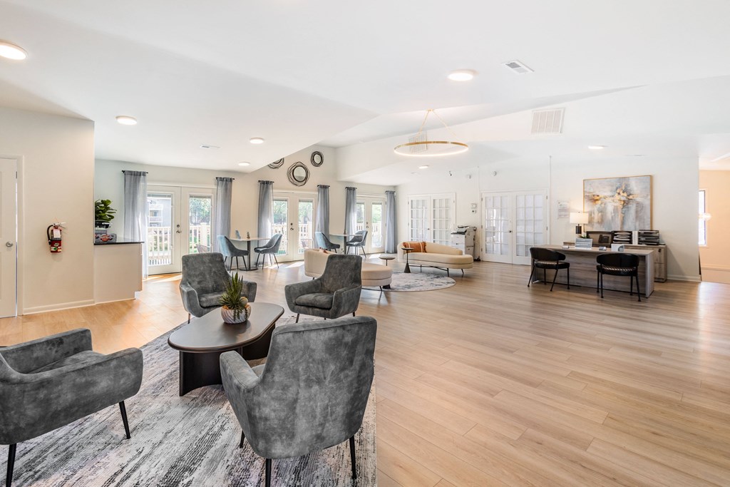 a living room with chairs and tables and a dining room