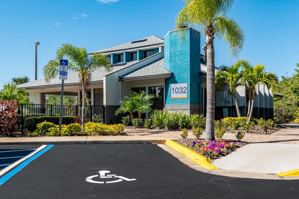 a parking lot with a wheelchair ramp in front of a building