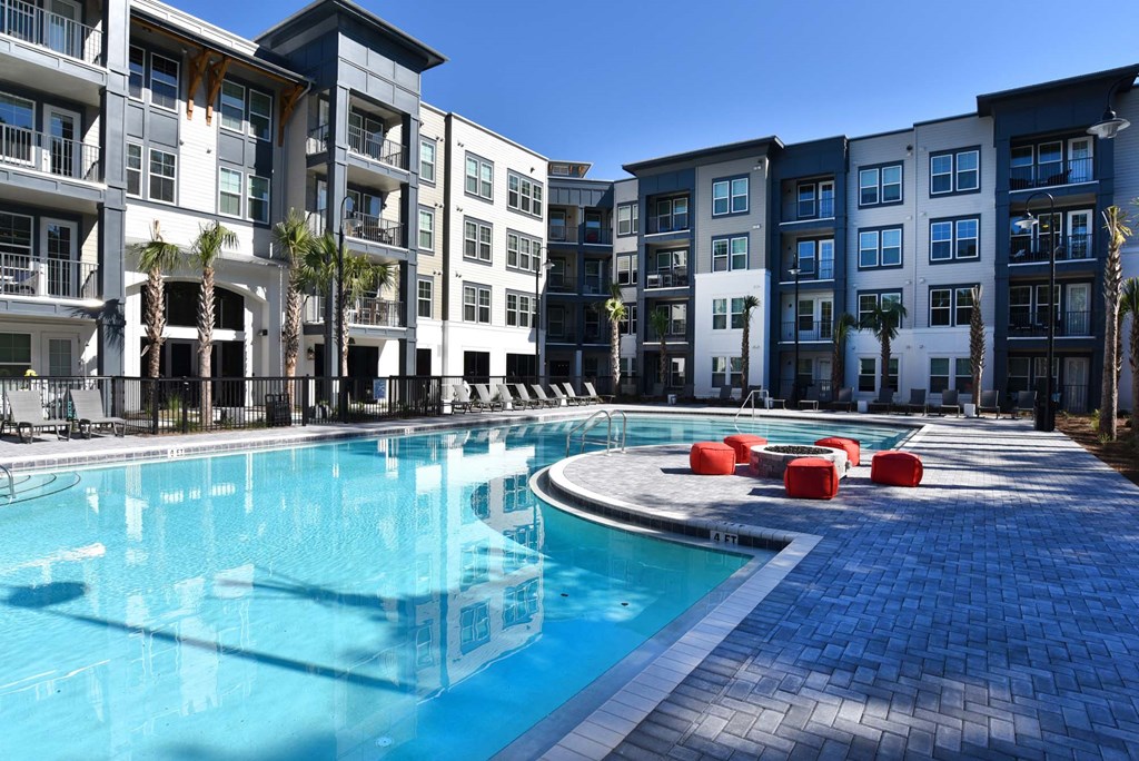 a large swimming pool in front of an apartment building