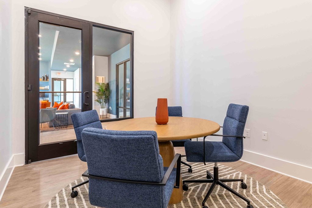 a dining room with a table and four chairs