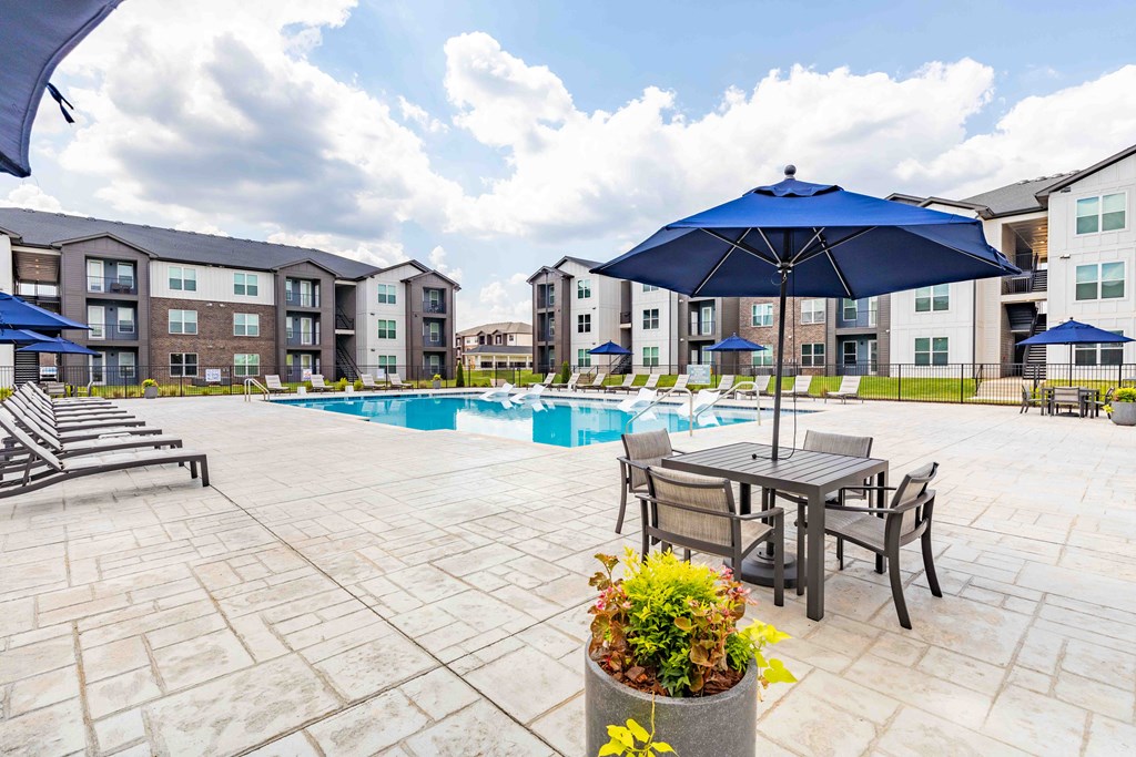 our apartments offer a swimming pool with tables and umbrellas