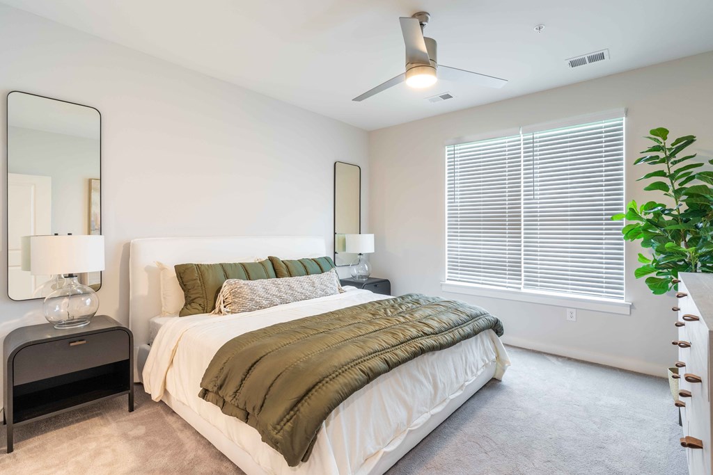 a bedroom with a large bed and a large window