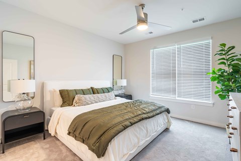 a bedroom with a large bed and a large window