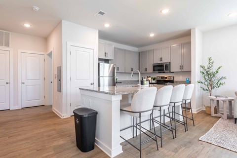 a kitchen with a large island and white cabinets