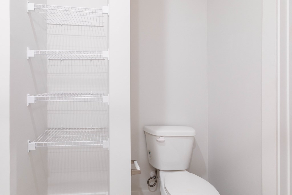 a small bathroom with a toilet and a closet