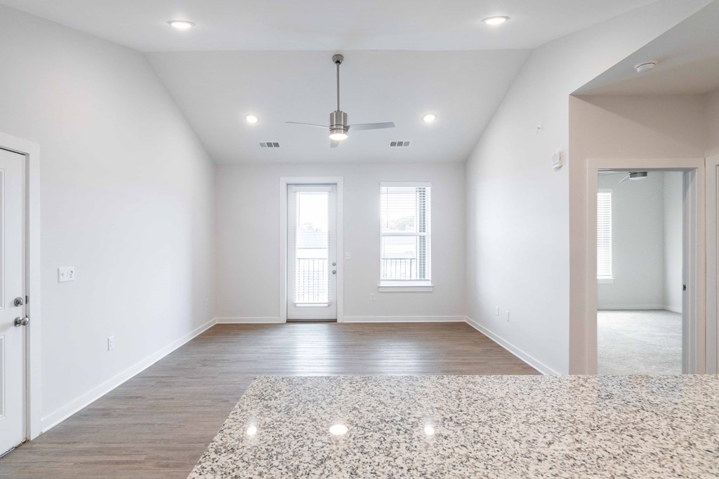 an empty living room with white walls and wood floors