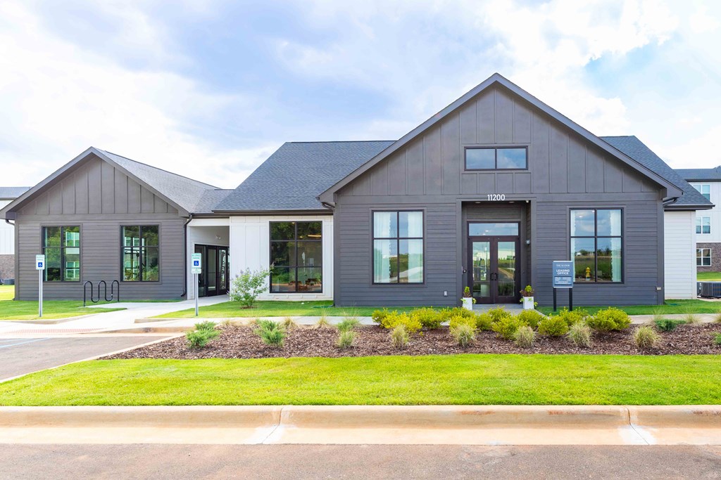 the exterior of a gray house with a lawn in front