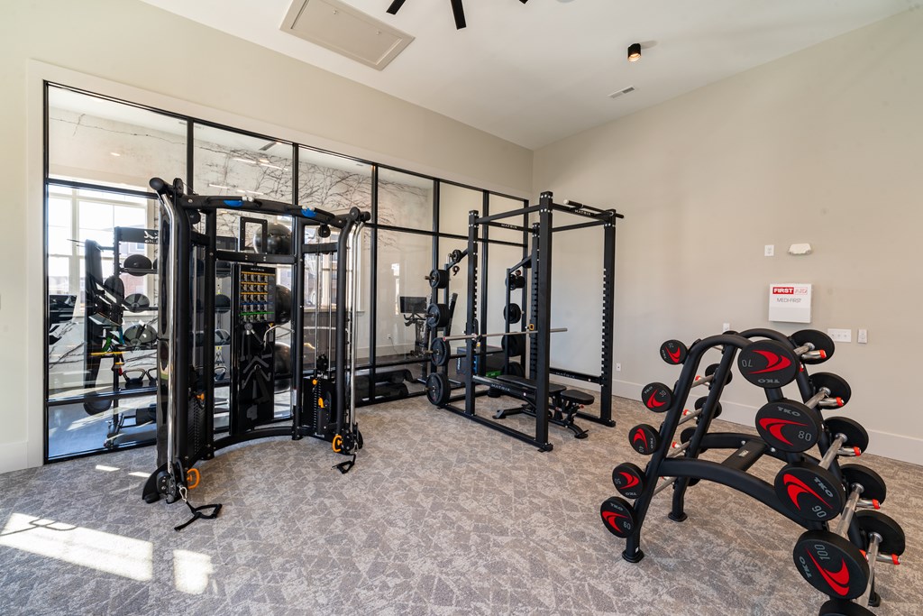Fitness center with cable machine and squat machine