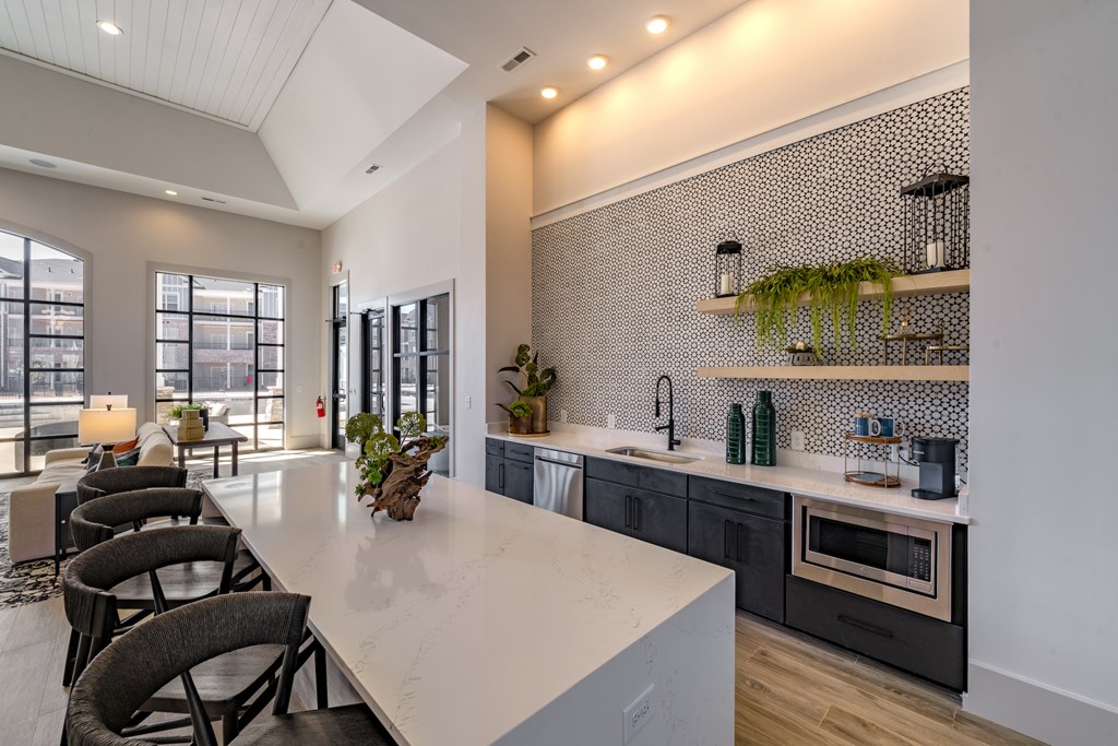 A modern kitchen with a dining table and chairs.