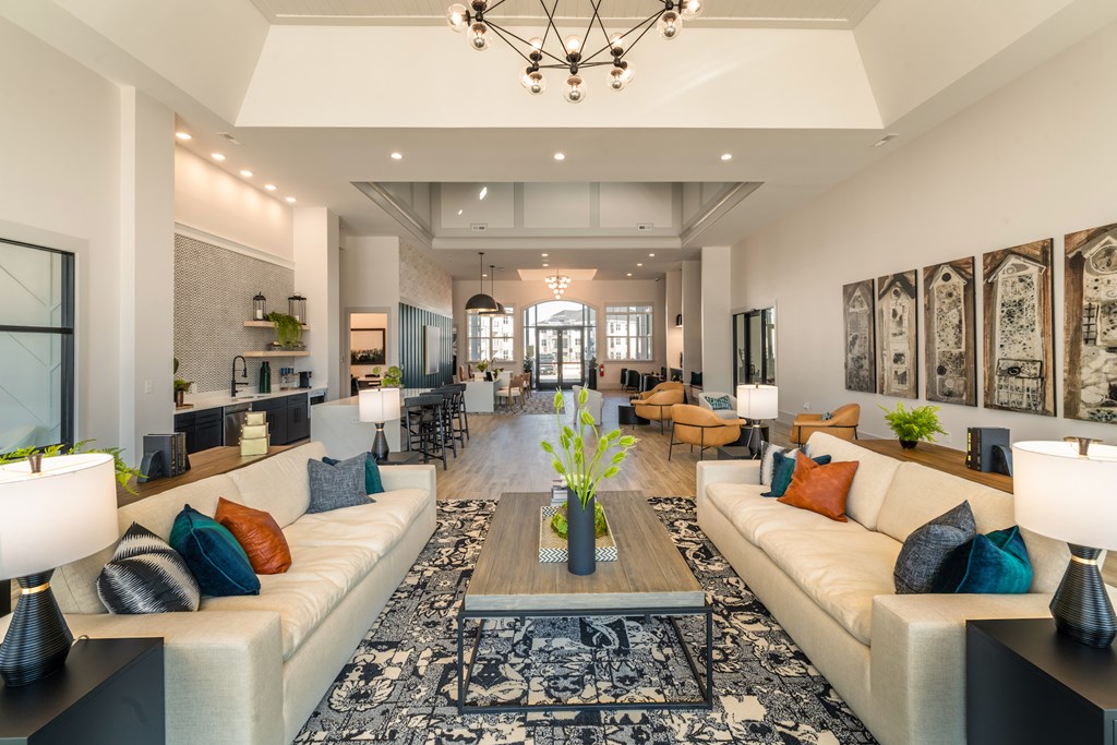 A spacious clubhouse with a central coffee table and a large sofa.