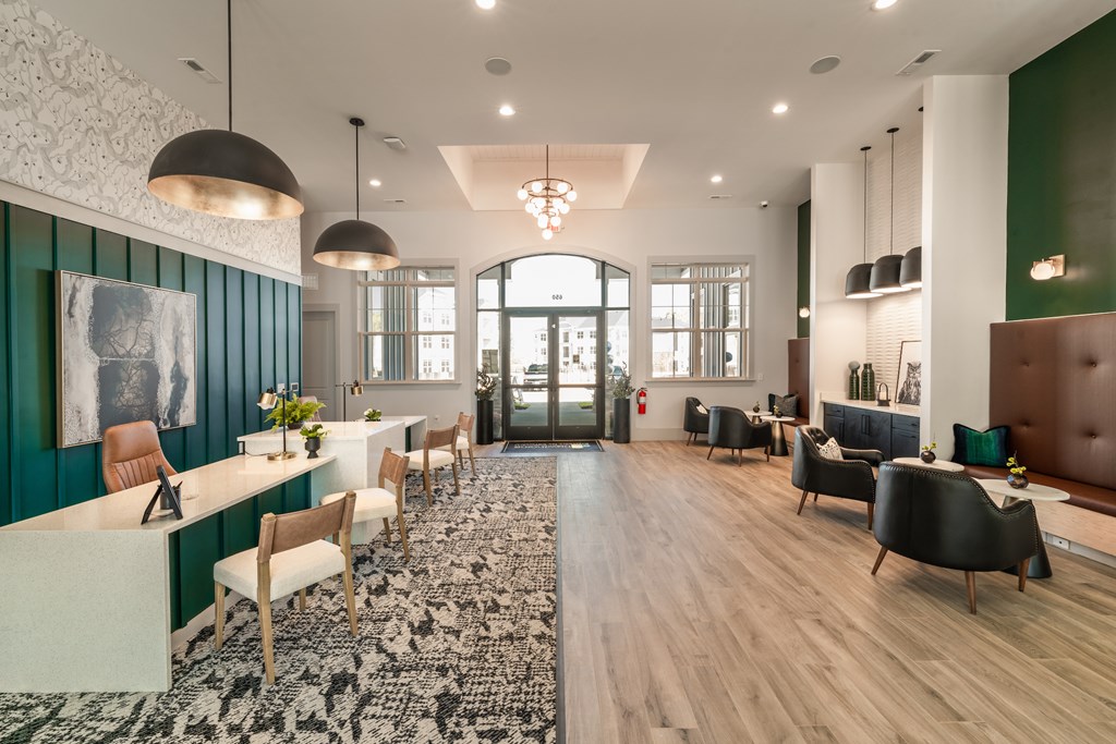 A modern clubhouse with tall ceilings and many chairs and tables