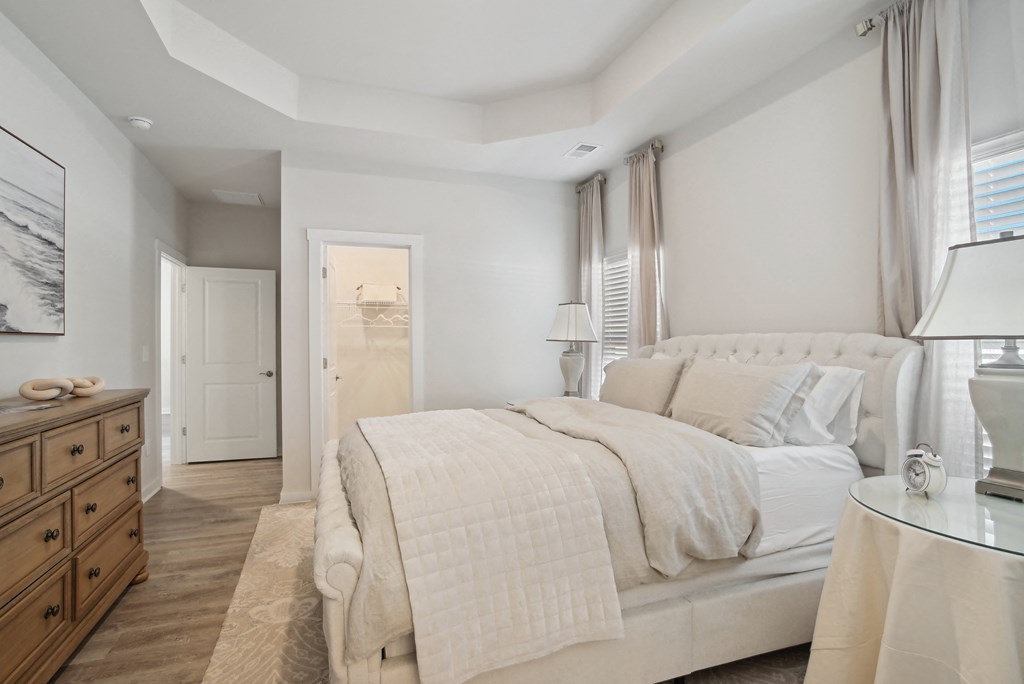 A bedroom with windows and a door to a bathroom at 15 at Heron apartments in Longs, SC.