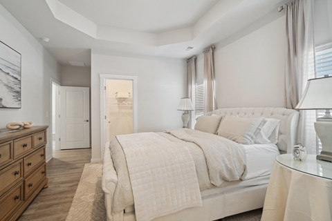 A bedroom with windows and a door to a bathroom at 15 at Heron apartments in Longs, SC.