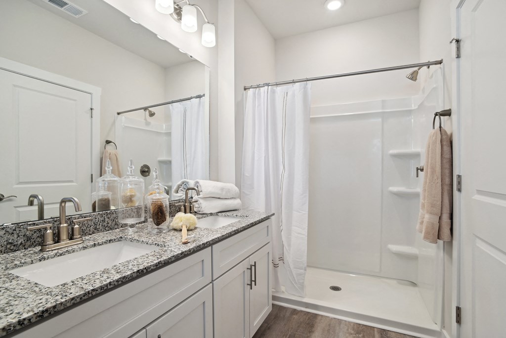 A bathroom with a sink and a shower and a mirror at 15 at Heron apartments in Longs, SC.