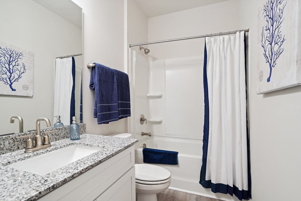 A bathroom with a shower/tub combo, sink and  toilet at 15 at Heron apartments in Longs, SC.