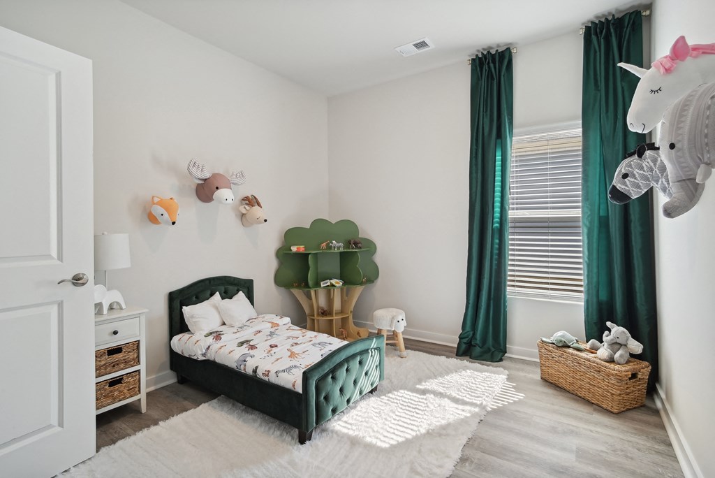 A child's bedroom with a bed and window at 15 at Heron apartments in Longs, SC.