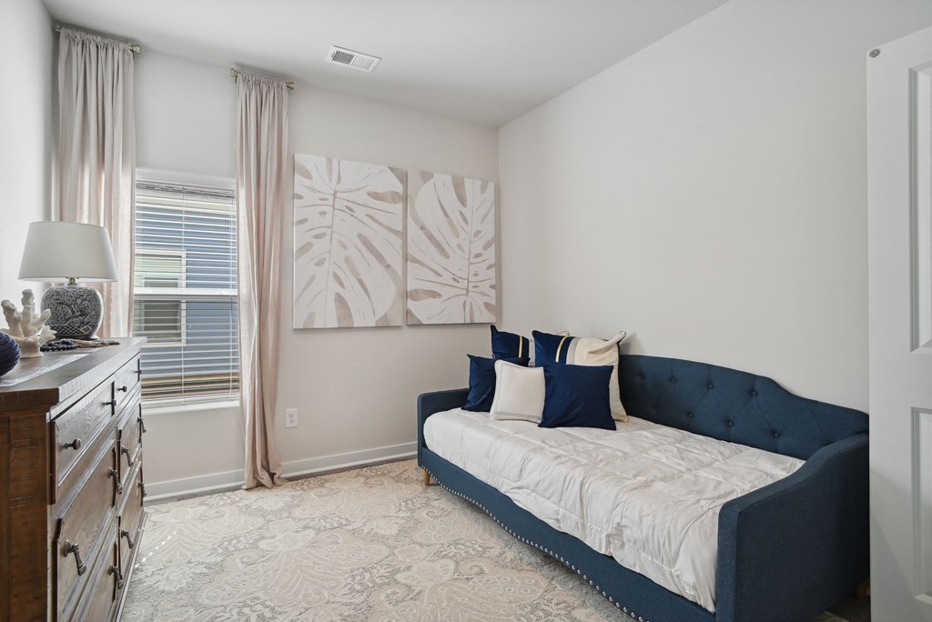 A bedroom with a bed and window at 15 at Heron apartments in Longs, SC.