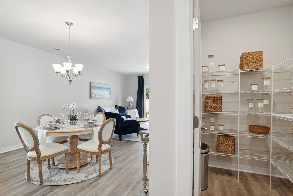 A dining room with a table and chairs and a pantry at 15 at Heron apartments in Longs, SC.