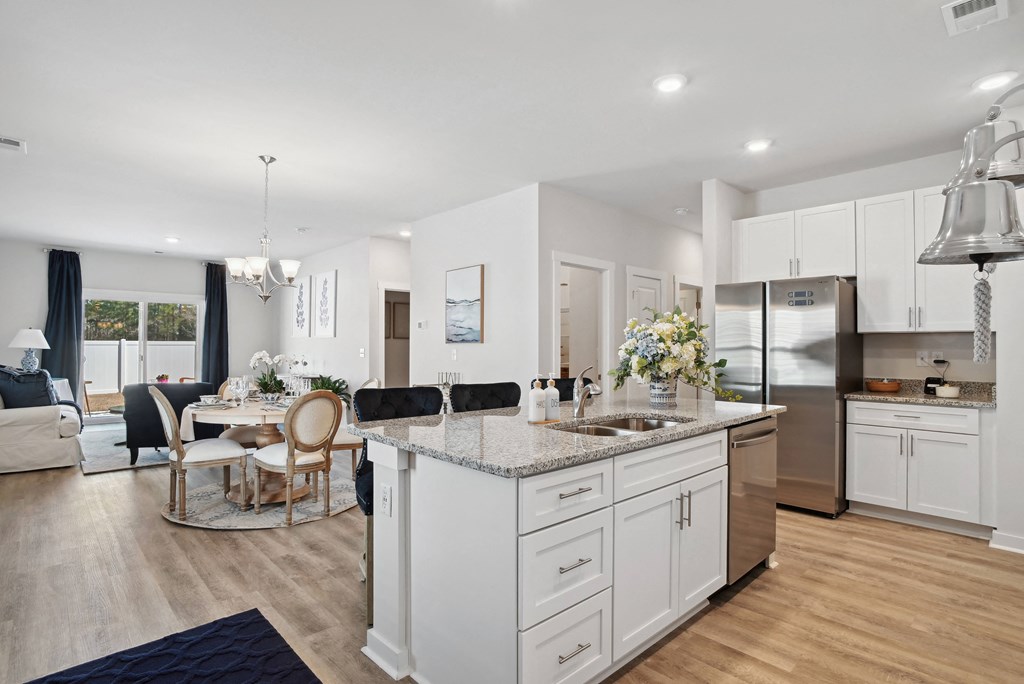 a kitchen with an island and a living room with a dining room