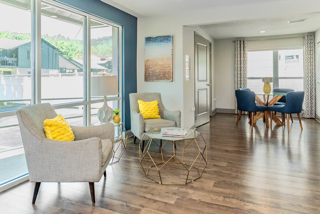 a living room with chairs and a table