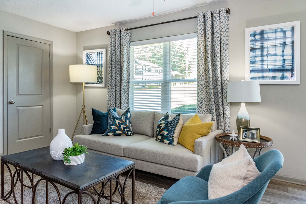 a living room with a couch and a window