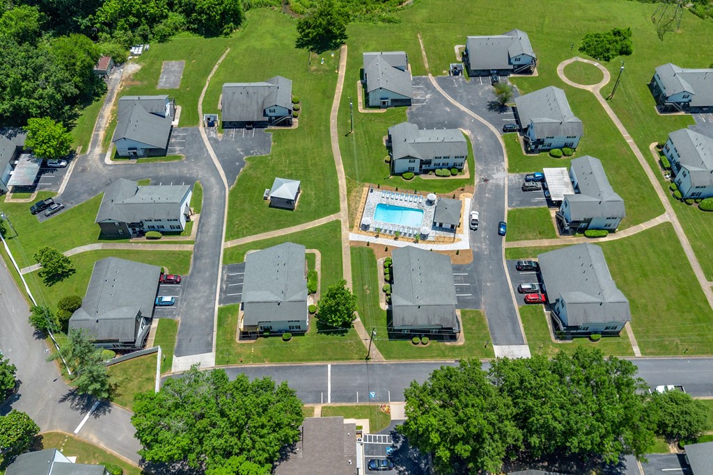 an aerial view of several mobile homes in a neighborhood with a swimming pool