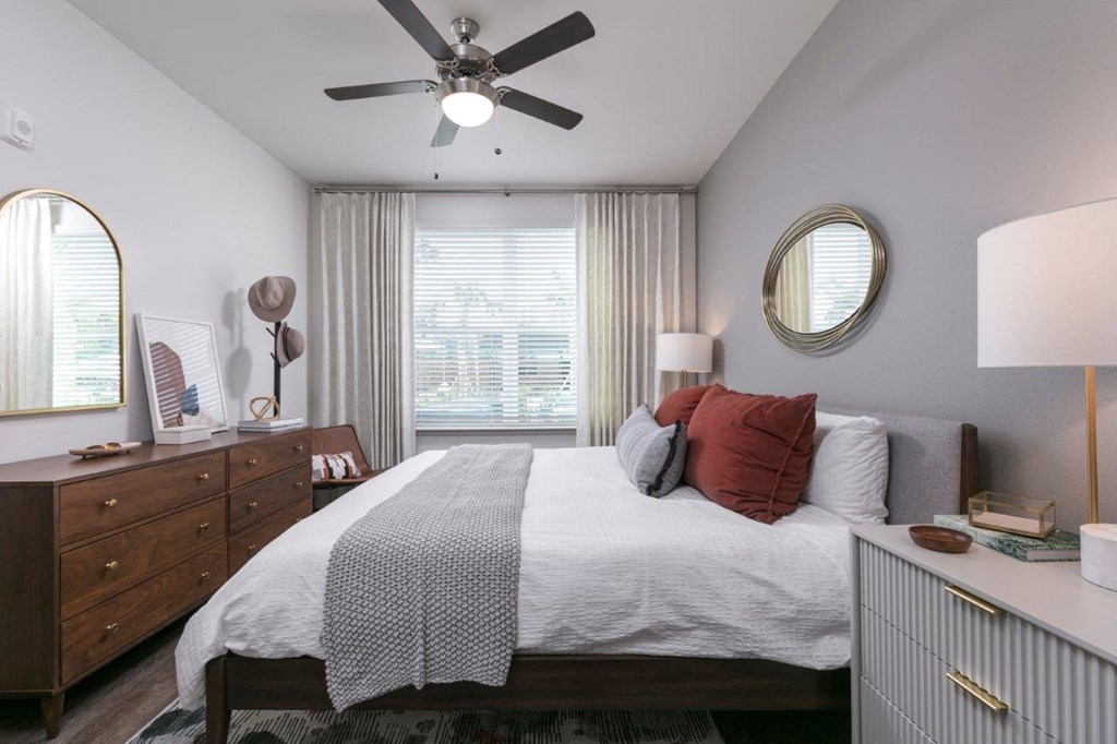 a bedroom with a bed and a ceiling fan