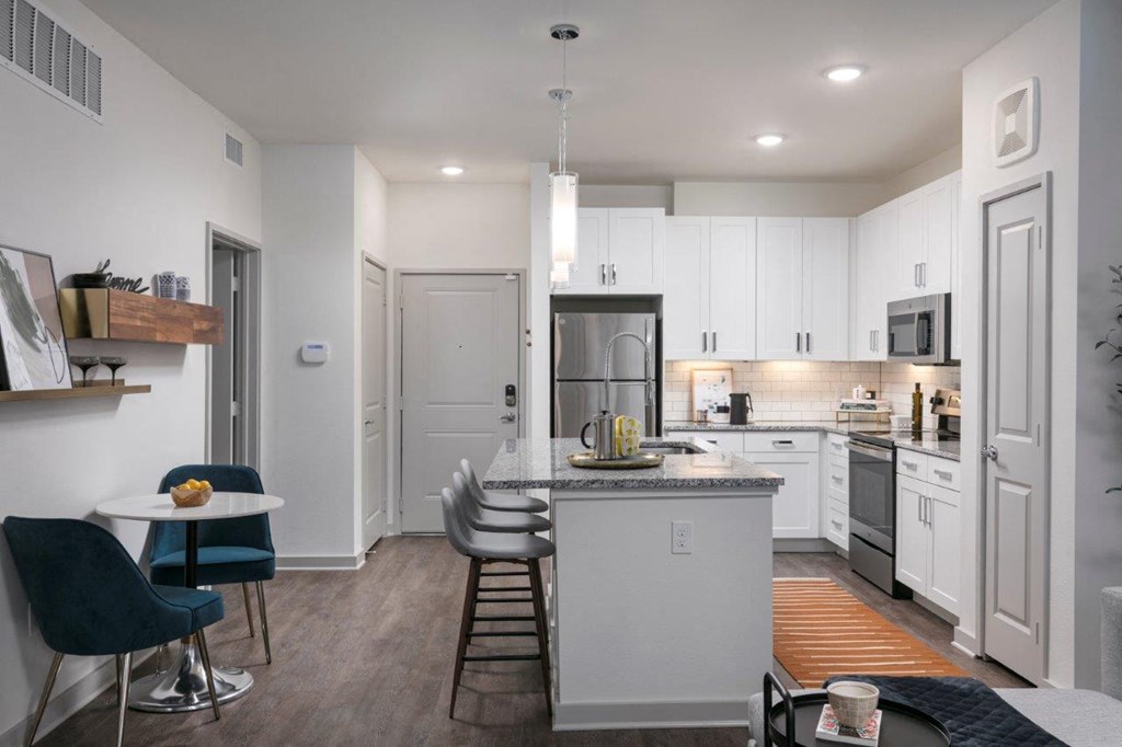 a kitchen with white cabinets and a counter top