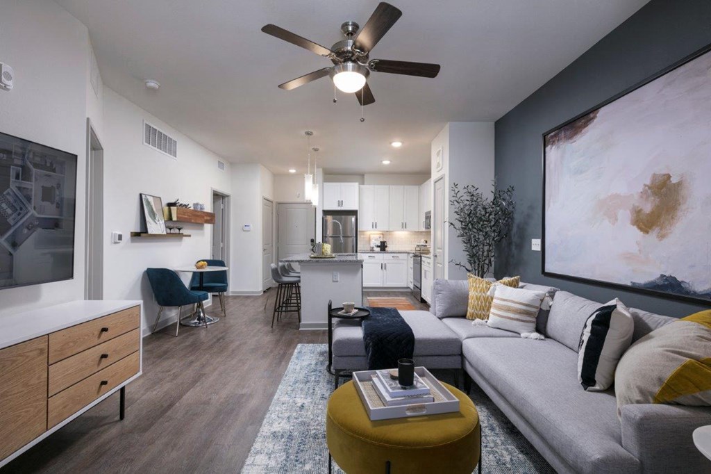 a living room with a couch and a ceiling fan