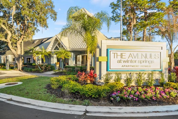 the sign in front of a building with palm trees