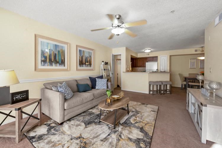 a living room with a couch and a ceiling fan