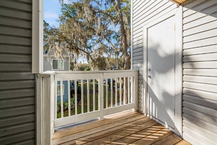 a porch with a white railing and a door