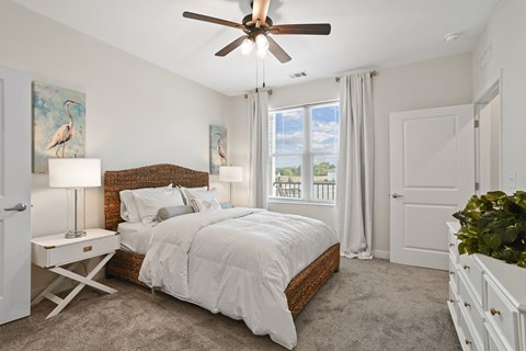 a bedroom with a bed and a ceiling fan