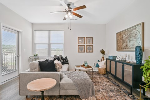 a living room with a couch and a ceiling fan