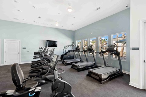 a room with a bunch of chairs and televisions in it