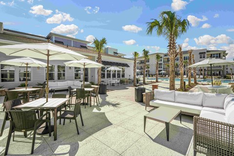 a rendering of a patio with tables and chairs and umbrellas