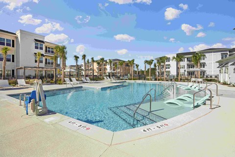 an aerial view of a swimming pool with buildings in the background