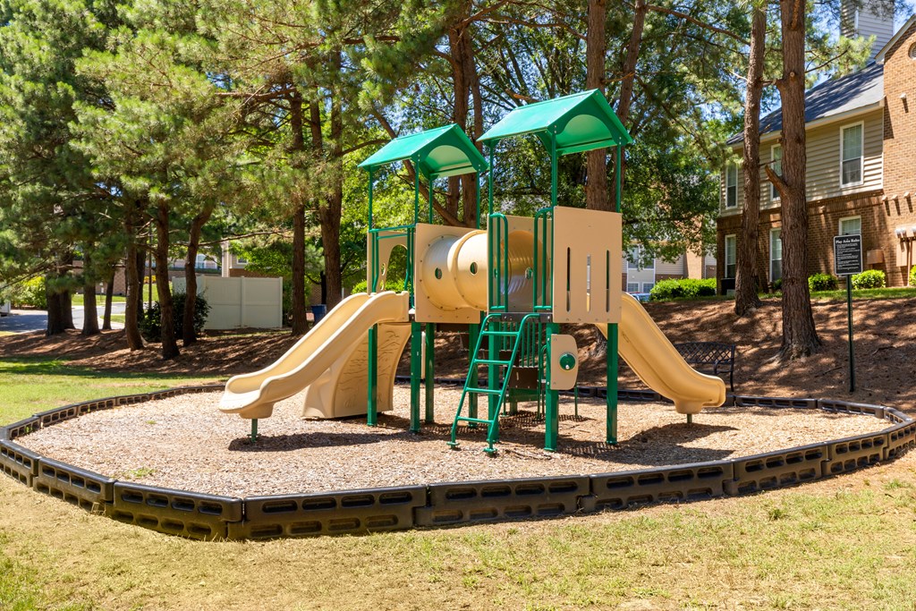 a playground with a yellow and green playset
