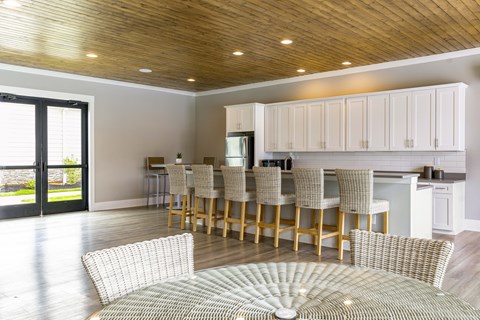 A modern kitchen with a dining table and chairs.