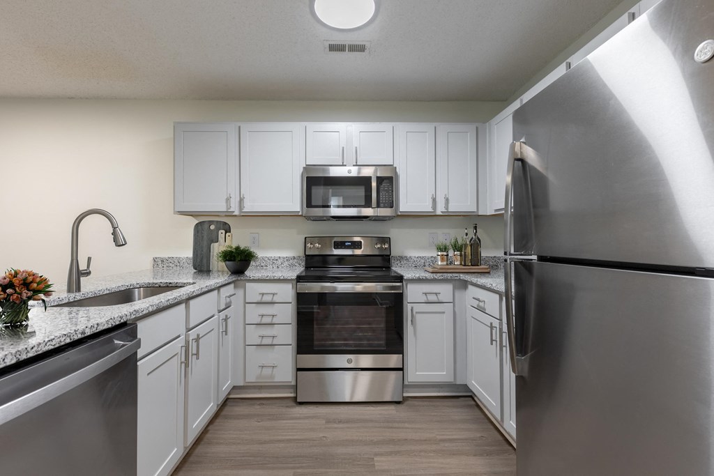 a kitchen with stainless steel appliances and white cabinets