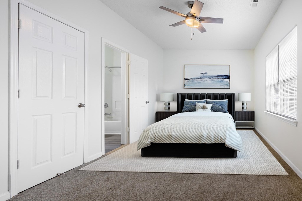 a bedroom with a bed and a ceiling fan