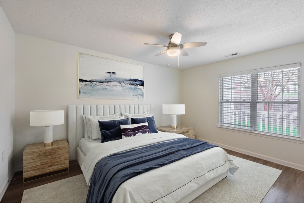 a bedroom with a bed and a ceiling fan