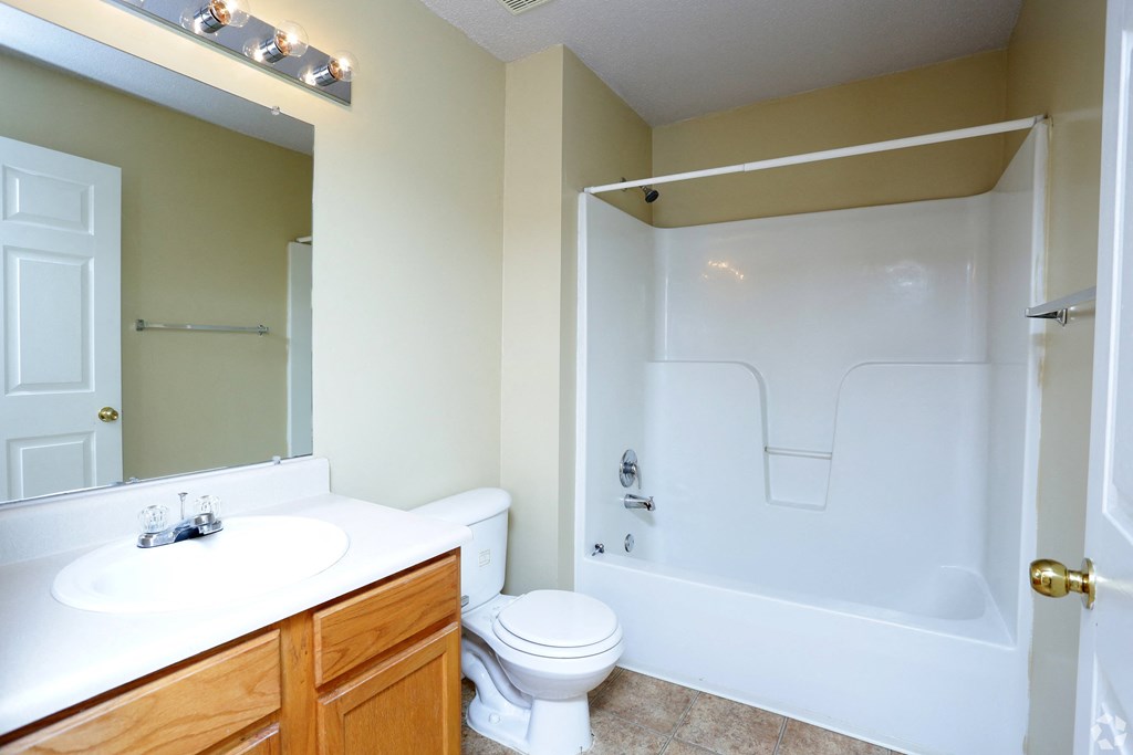 a bathroom with a sink toilet and a tub