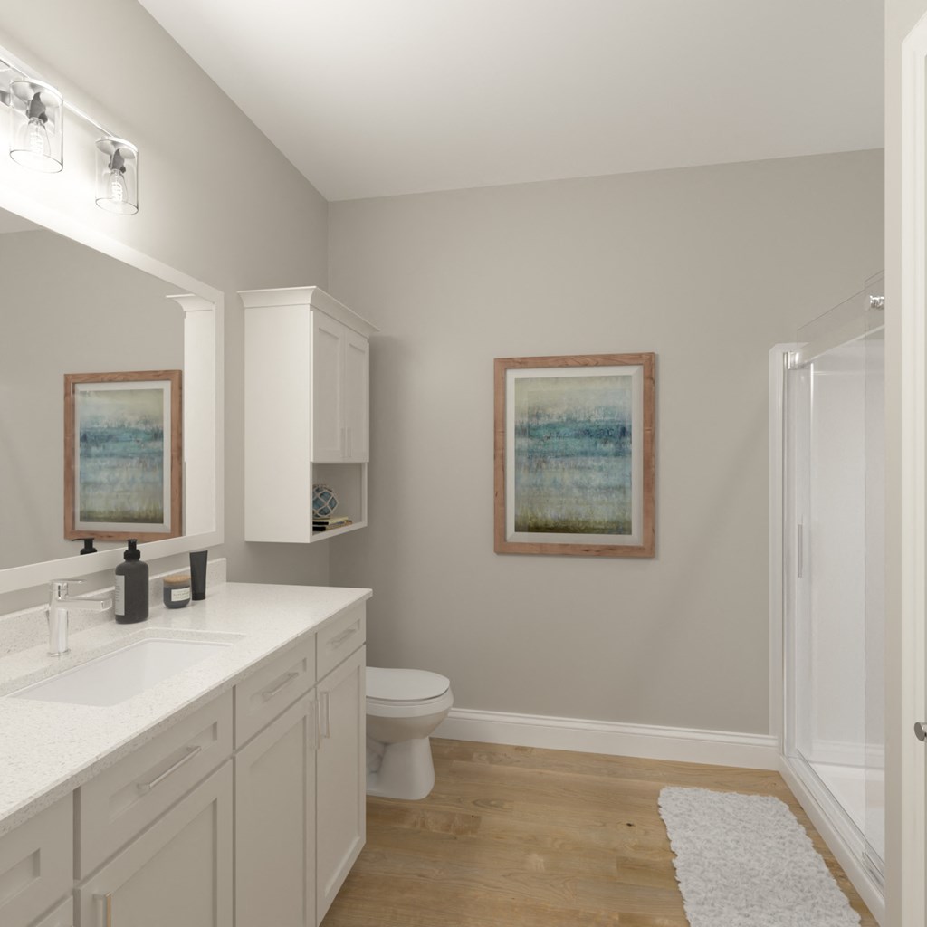 a white bathroom with two paintings on the wall