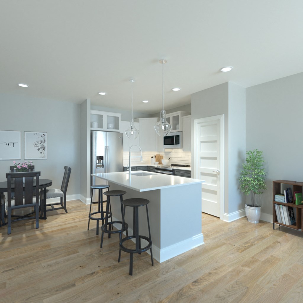 a large kitchen with a white island and a dining room